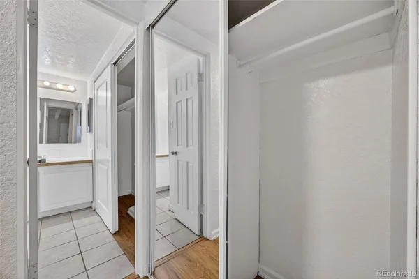 a view of a hallway with wooden floor and entryway