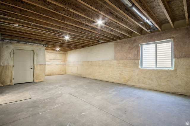 3322 250 S Street Vernal, UT 84078 - Photo 28 of 37 Unfinished basement featuring exposed joists, concrete flooring, a window with blinds, recessed lighting, and a paneled door