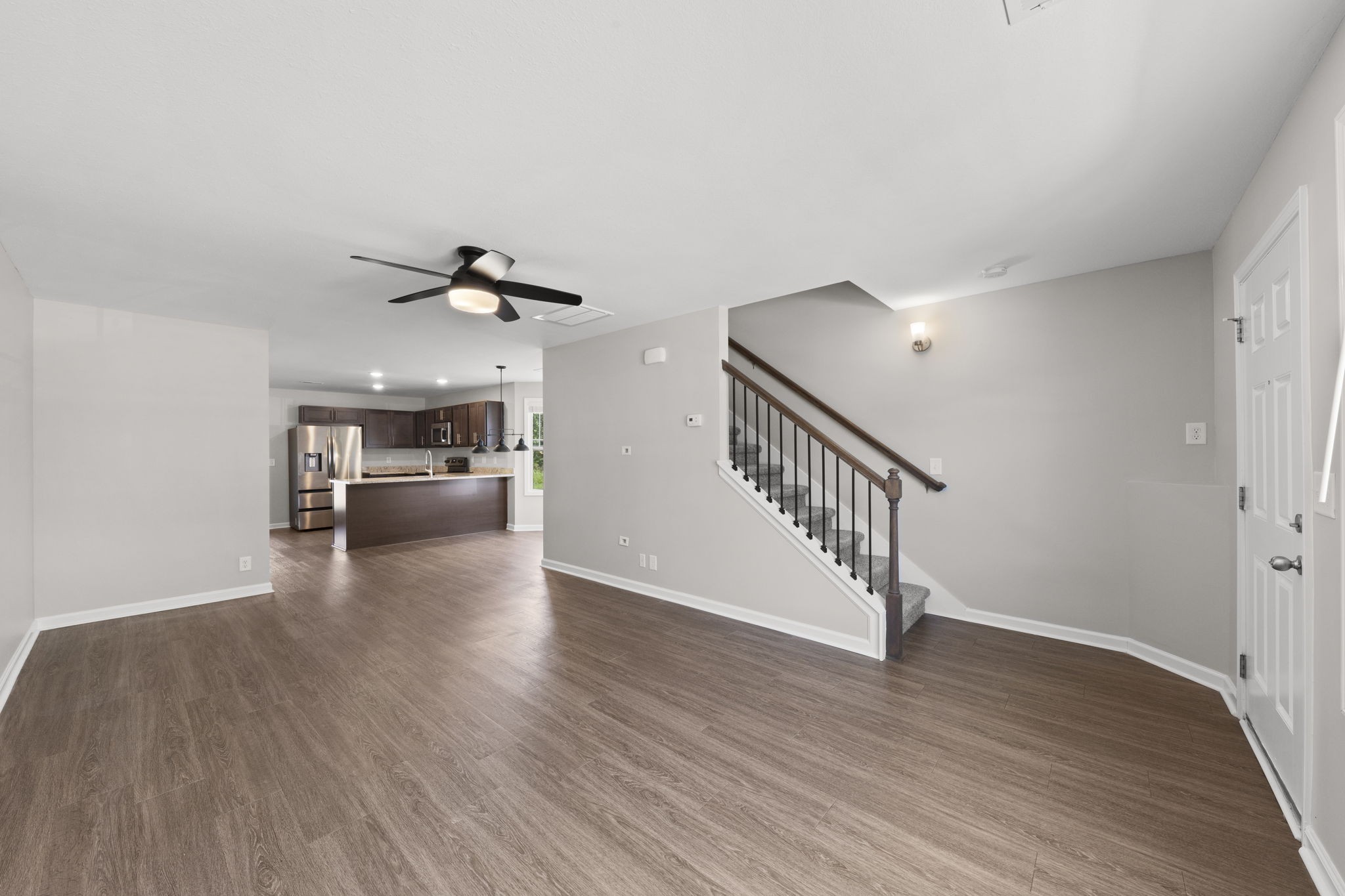 119 Davis Ridge Lane Clarksville, TN 37040 - Photo 8 of 30 a view of a livingroom with wooden floor staircase and kitchen view