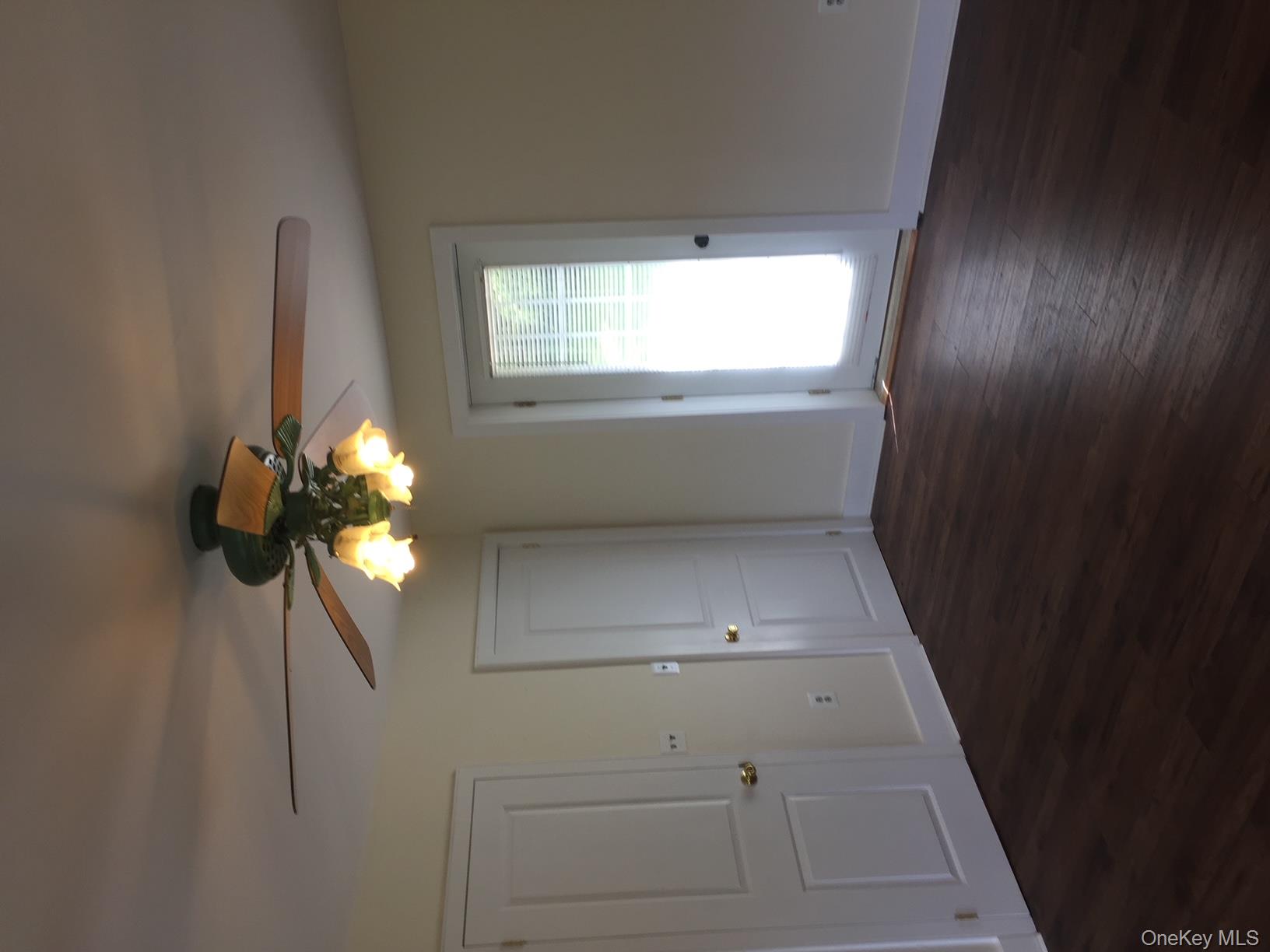 8064 Albany Post Road Red Hook, NY 12571 - Photo 11 of 21 a view of an empty room with wooden floor and a window