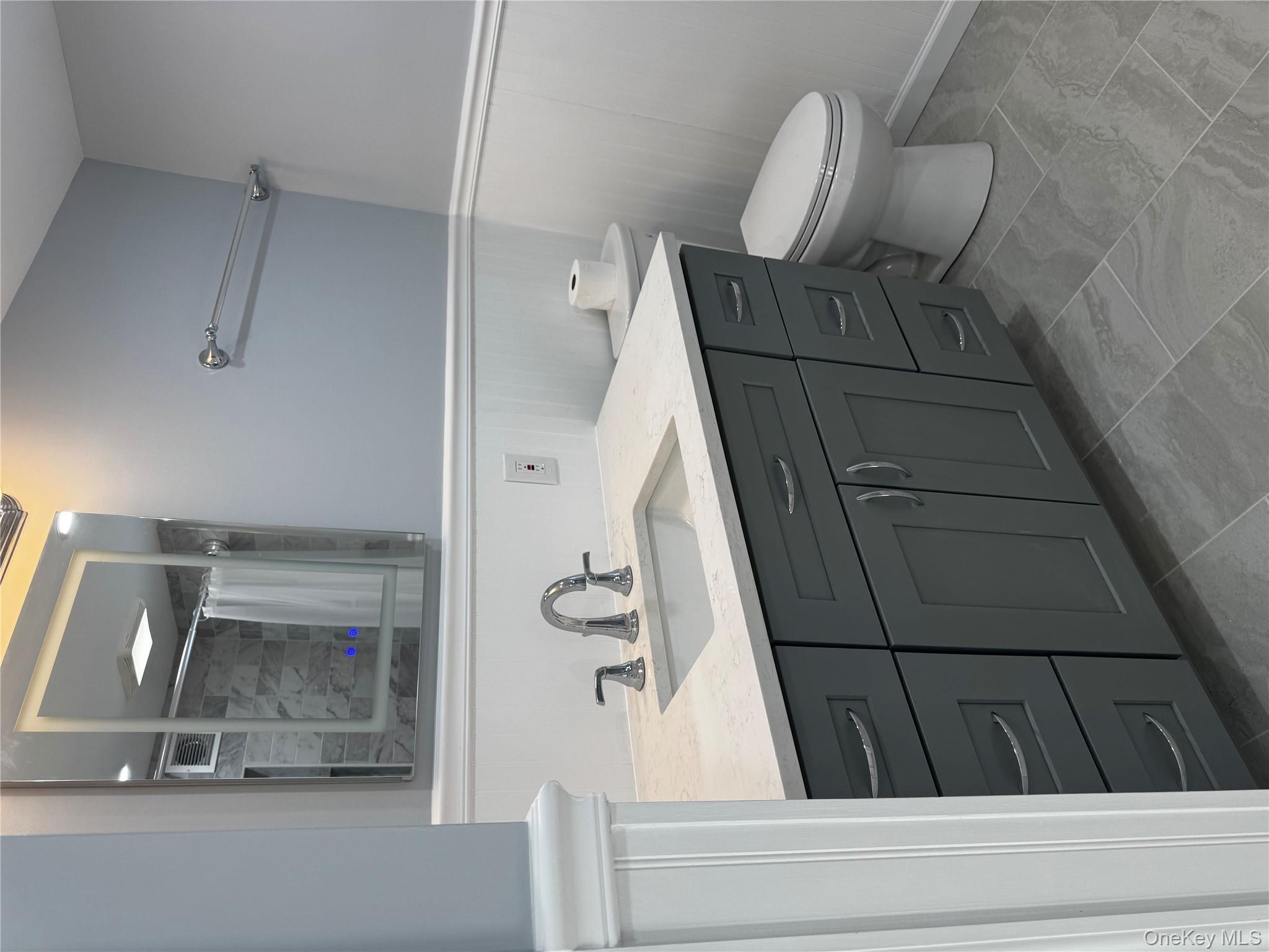 8064 Albany Post Road Red Hook, NY 12571 - Photo 2 of 21 a bathroom with a toilet sink and mirror