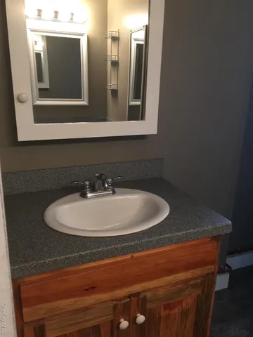 a bathroom with a sink and mirror