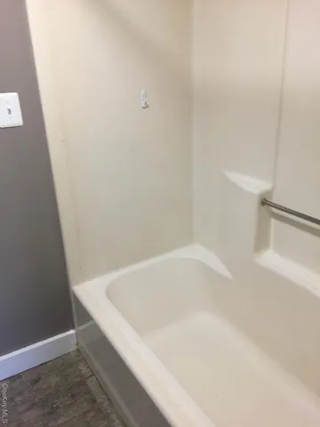 a white bath tub sitting next to a white toilet