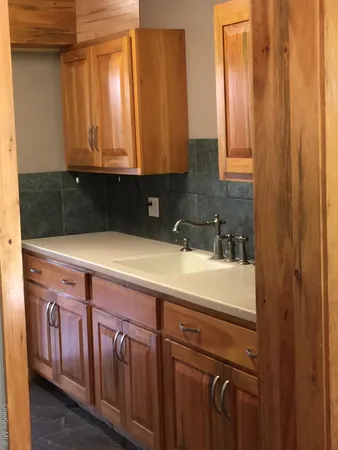 a view of a sink and cabinets