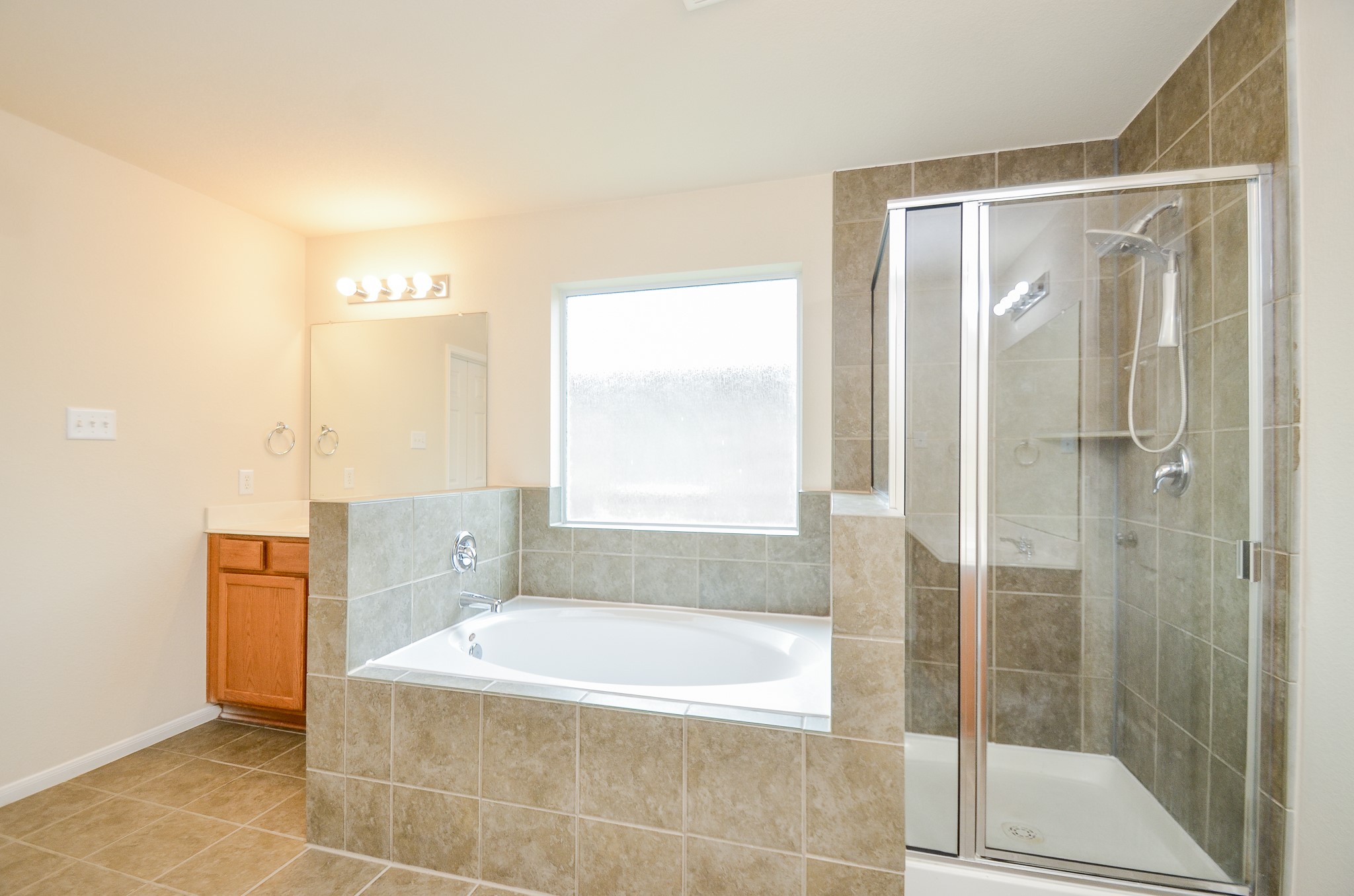 2903 Gaelic Green Street Houston, TX 77045 - Photo 17 of 32 a bathroom with a bathtub and a shower