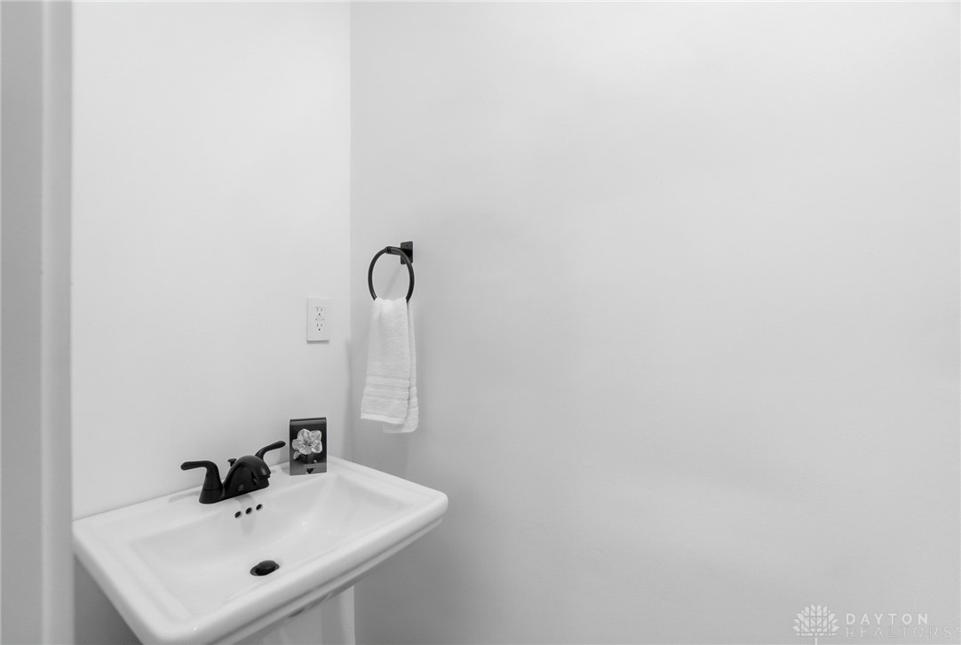 25 Englewood Road Springfield, OH 45504 - Photo 31 of 66 This bathroom features a contemporary pedestal sink with sleek fixtures, offering a clean aesthetic.