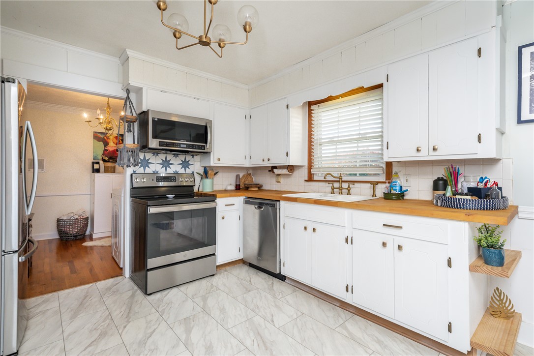 401 South Glassy Mountain Road Pickens, SC 29671 - Photo 26 of 37 This bright kitchen features white cabinetry and wood countertops, perfect for culinary endeavors.