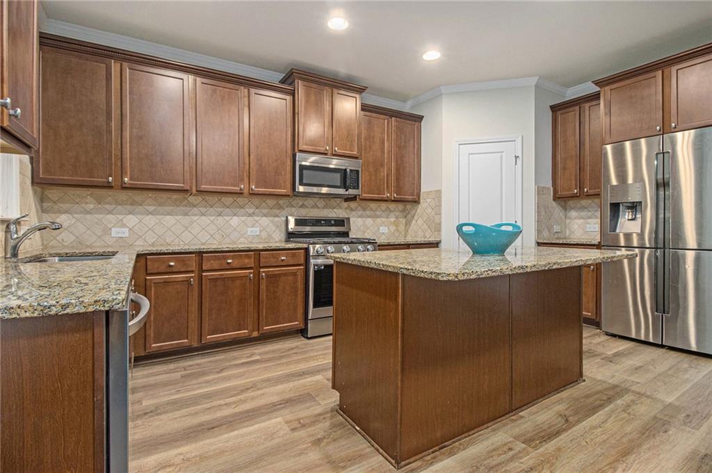 218 Third Avenue Avondale Estates, GA 30002 - Photo 13 of 26 a kitchen with stainless steel appliances granite countertop a refrigerator a stove a sink and a microwave