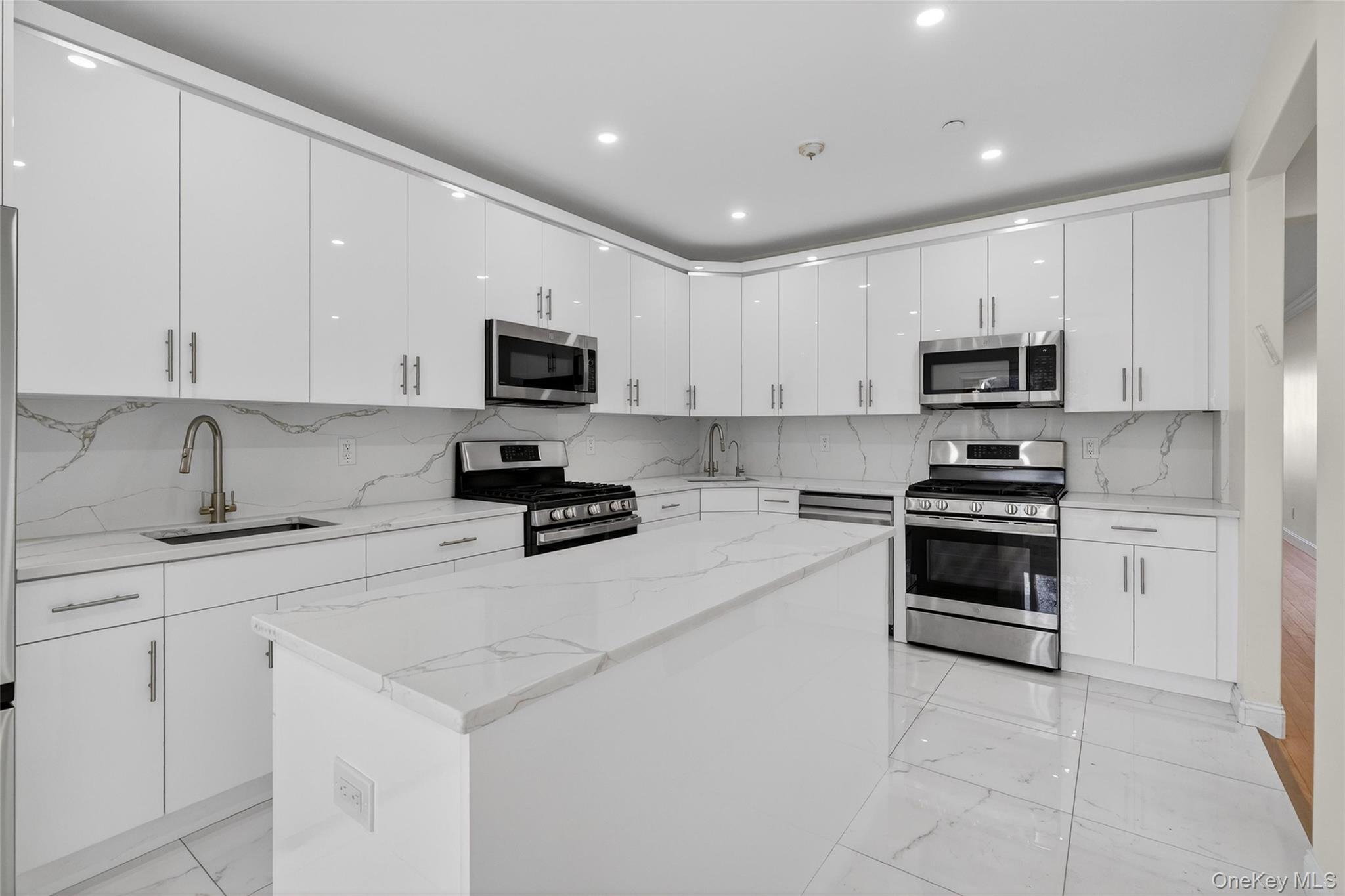 2 Bluefield Drive, Unit 103 Spring Valley, NY 10977 - Photo 4 of 38 a kitchen with granite countertop a stove a sink and a microwave