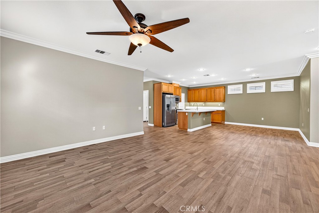 215 Firestone Lane Hemet, CA 92545 - Photo 16 of 61 an empty room with wooden floor and windows