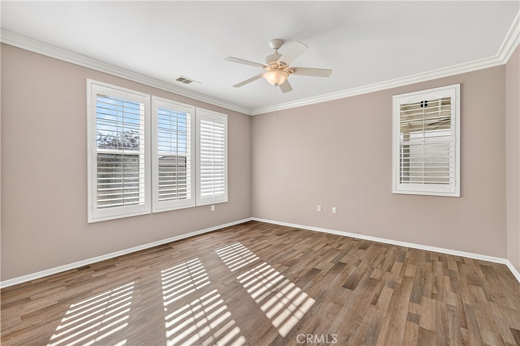 215 Firestone Lane Hemet, CA 92545 - Photo 28 of 61 a view of an empty room with wooden floor and a window