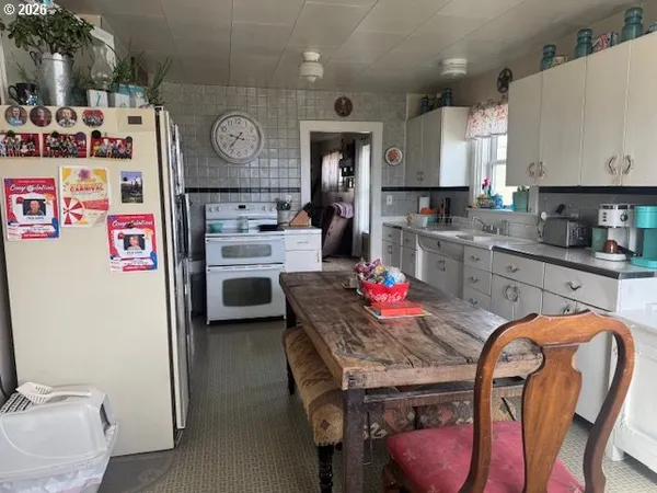 a kitchen with stainless steel appliances granite countertop a sink dishwasher and refrigerator with wooden floor