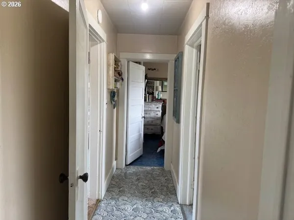 a view of a hallway with a livingroom and dining room