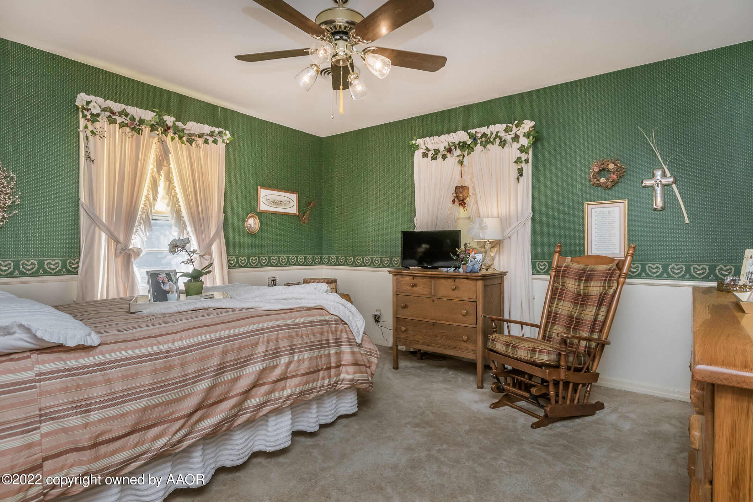 1538 Bell Street Amarillo, TX 79106 - Photo 18 of 26 a bedroom with a bed and a chandelier