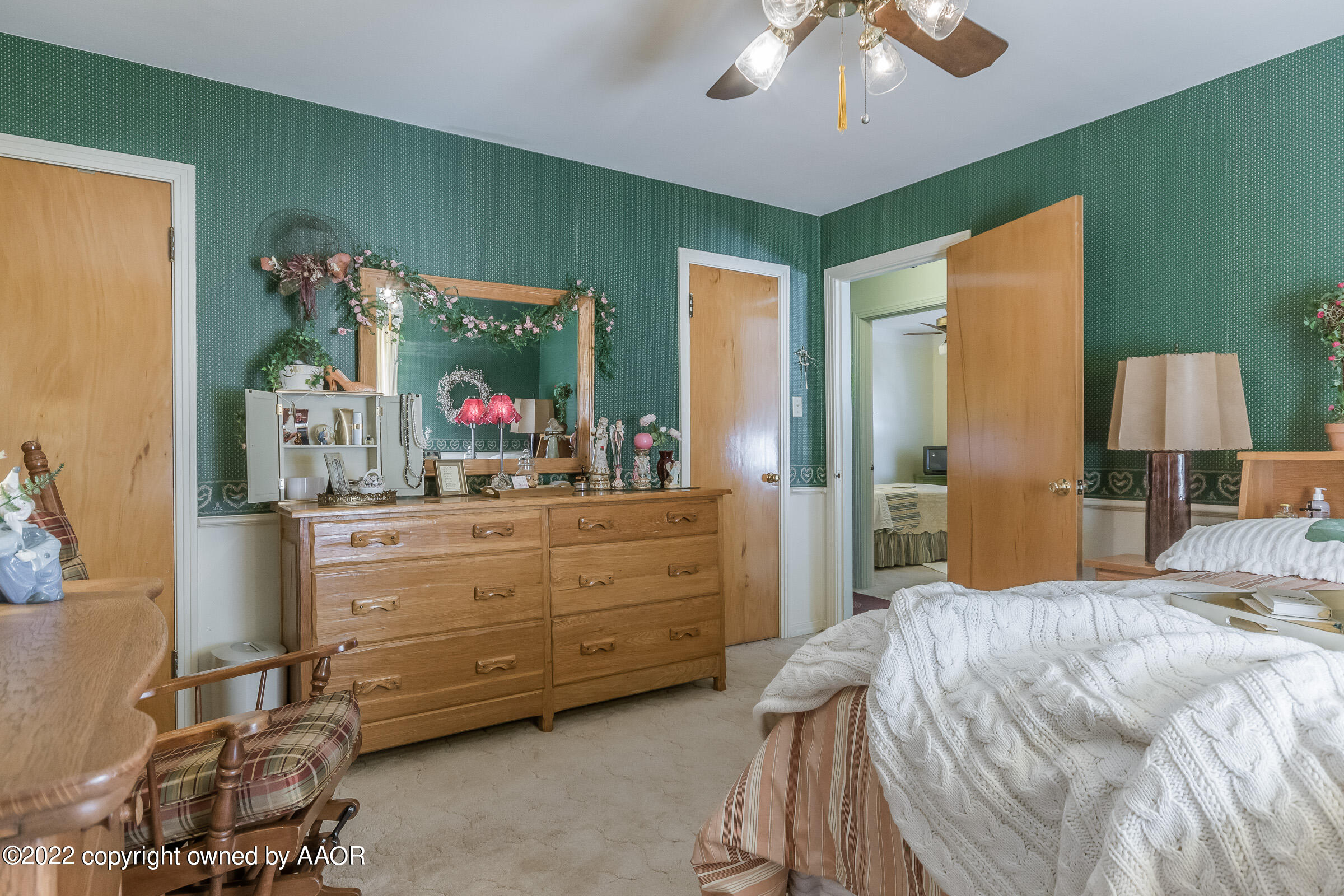 1538 Bell Street Amarillo, TX 79106 - Photo 19 of 26 a bedroom with a bed and a mirror on dresser