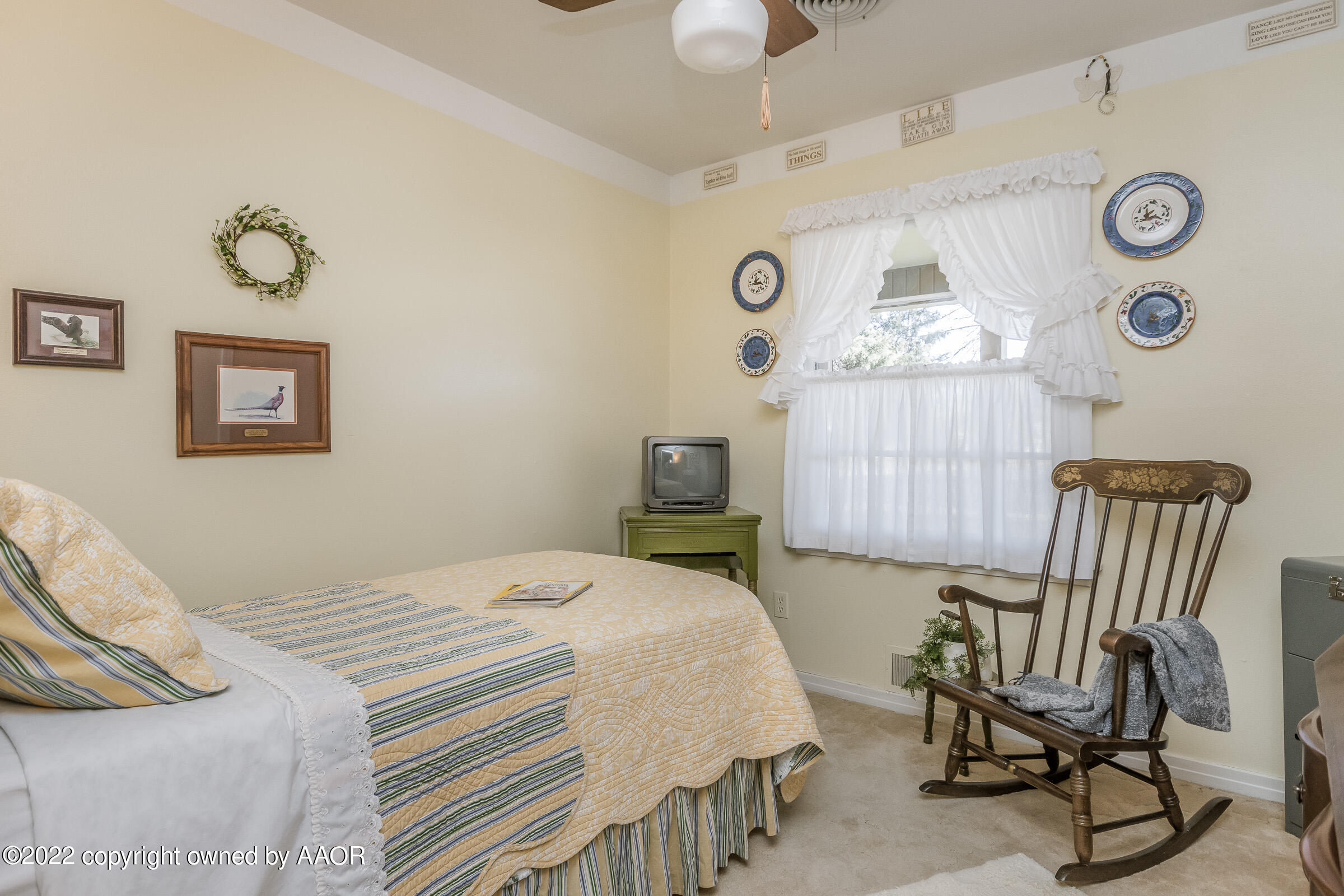 1538 Bell Street Amarillo, TX 79106 - Photo 22 of 26 a bedroom with a bed and a chair