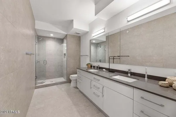 a bathroom with a shower a toilet and a sink