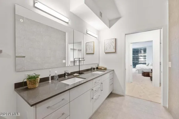 a bathroom with a granite countertop toilet sink and shower