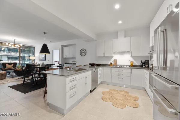 a kitchen with granite countertop a sink stove and cabinets
