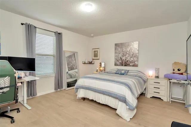 a large kitchen with stainless steel appliances a large counter top a stove and a refrigerator