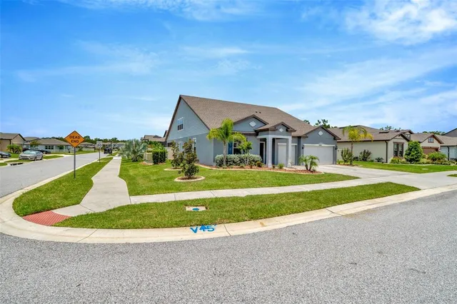 a living room with couches a large dining table and with a large window