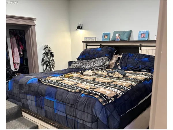 a bed sitting in a bedroom next to a window