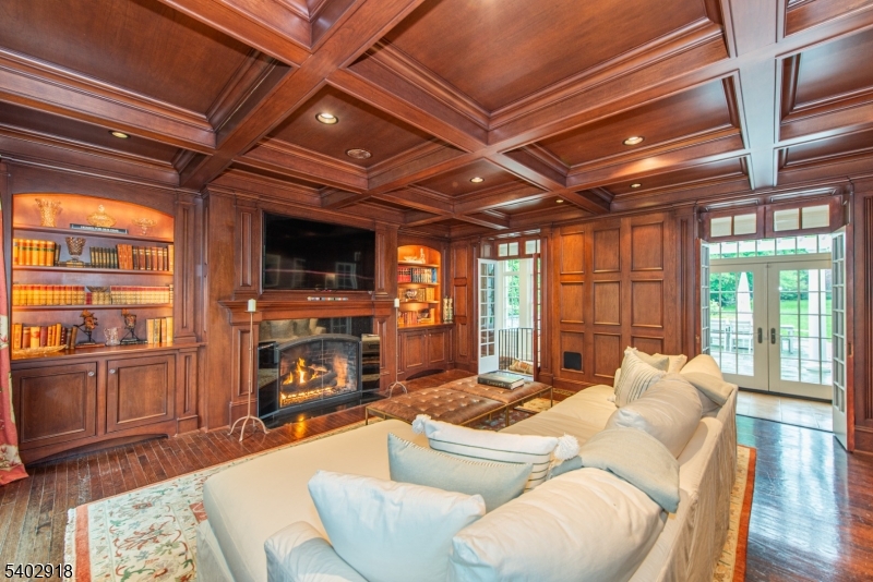 412 Ridgewood Avenue Glen Ridge, NJ 07028 - Photo 18 of 48 a living room with furniture a fireplace and a flat screen tv