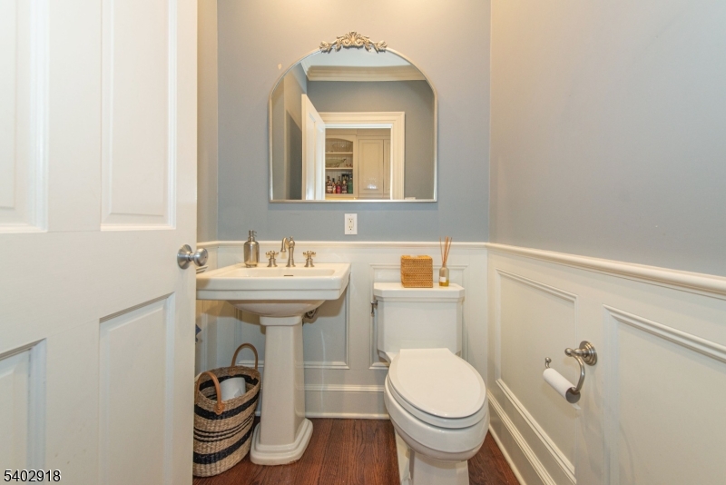 412 Ridgewood Avenue Glen Ridge, NJ 07028 - Photo 19 of 48 a bathroom with a toilet sink and mirror