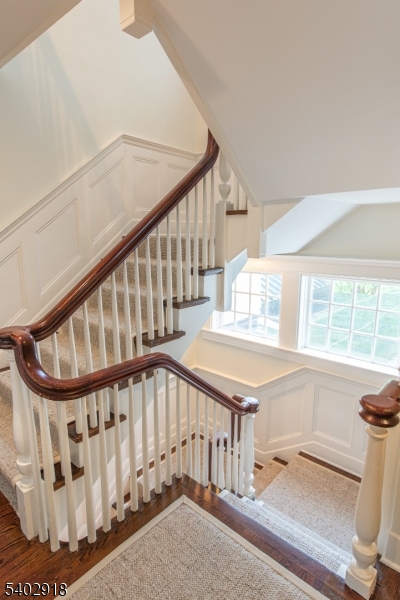 412 Ridgewood Avenue Glen Ridge, NJ 07028 - Photo 21 of 48 a view of staircase with white walls and a window