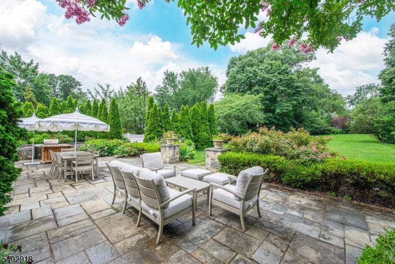 412 Ridgewood Avenue Glen Ridge, NJ 07028 - Photo 39 of 48 a view of a patio with a table and chairs under an umbrella