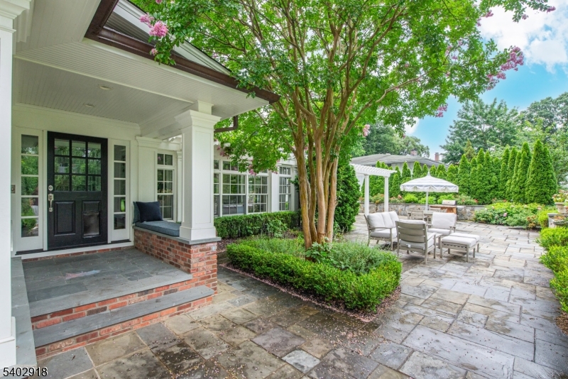 412 Ridgewood Avenue Glen Ridge, NJ 07028 - Photo 40 of 48 a view of a patio with table and chairs potted plants and large tree