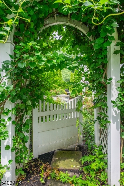 412 Ridgewood Avenue Glen Ridge, NJ 07028 - Photo 41 of 48 a view of a bench in a garden