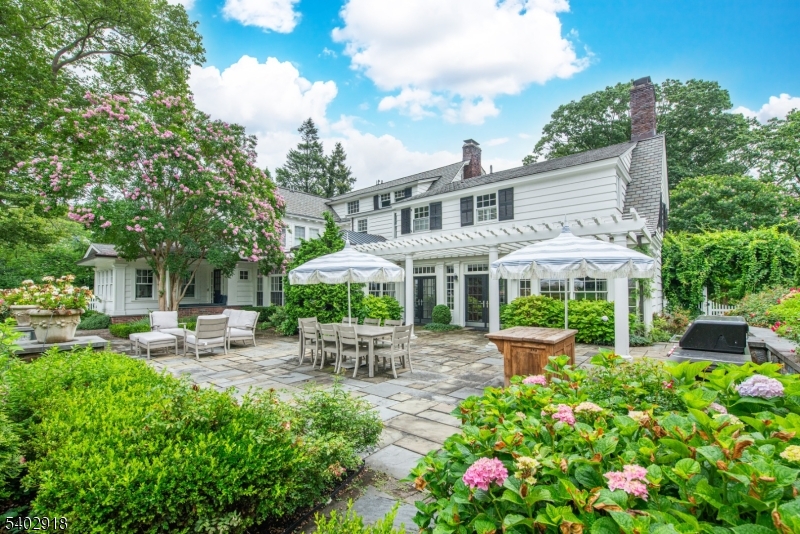 412 Ridgewood Avenue Glen Ridge, NJ 07028 - Photo 44 of 48 a view of a patio with table and chairs under an umbrella