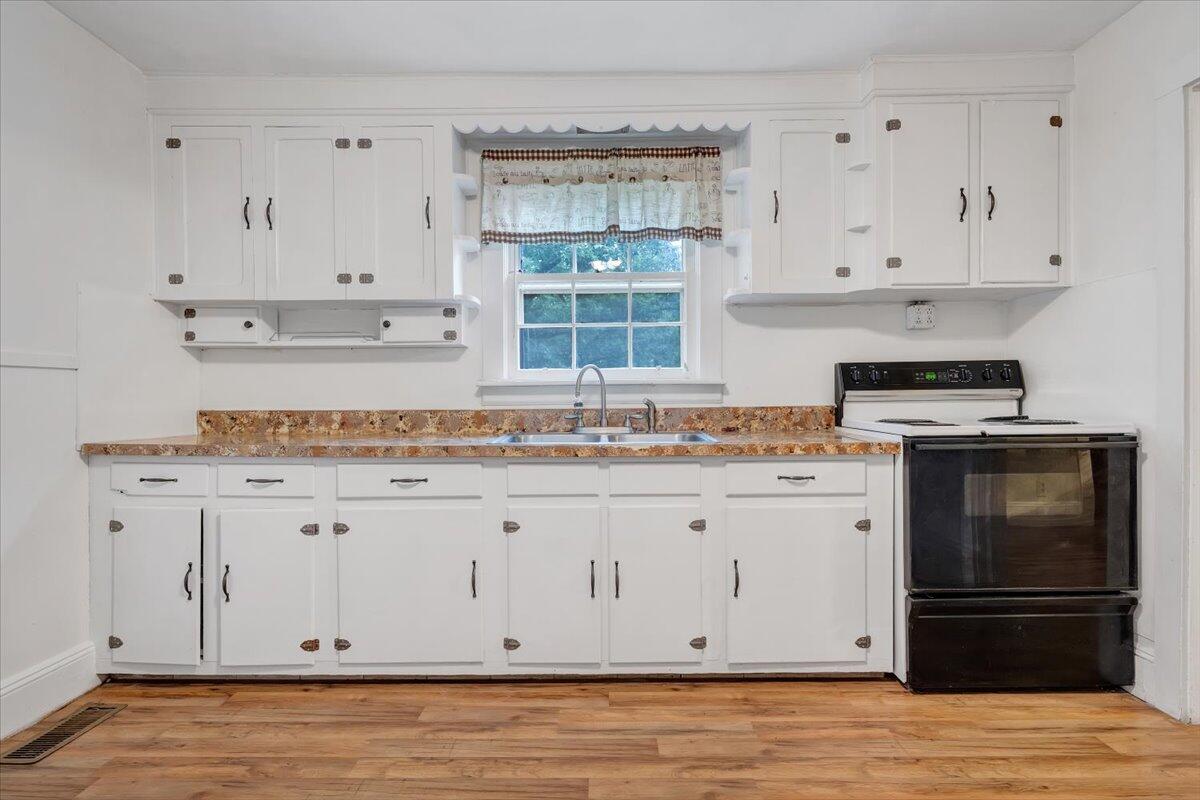 4393 Daugherty Road Salem, VA 24153 - Photo 7 of 24 a kitchen with granite countertop white cabinets and stainless steel appliances