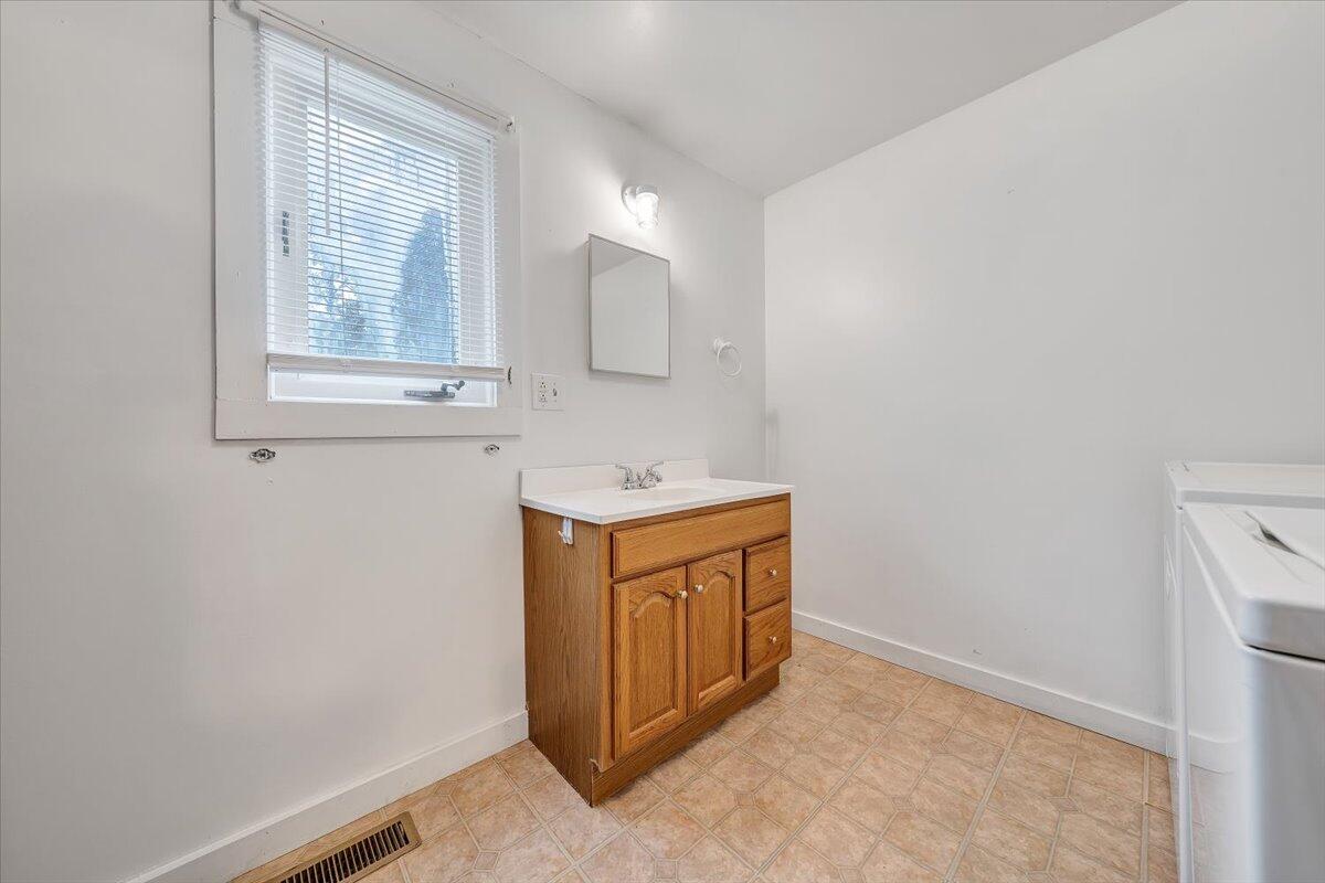 4393 Daugherty Road Salem, VA 24153 - Photo 9 of 24 a bathroom with a sink a vanity and mirror