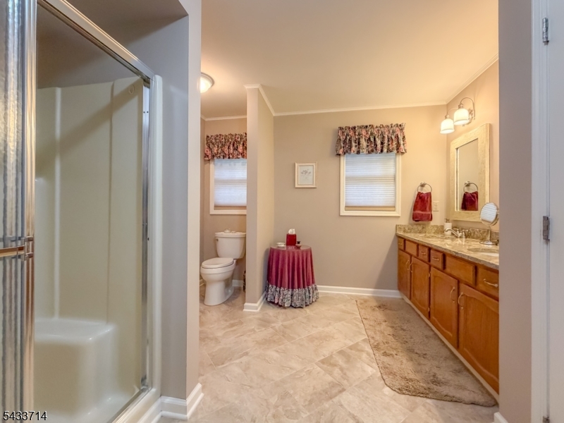 29 Lark Lane Oak Ridge, NJ 07438 - Photo 17 of 26 a large bathroom with a granite countertop sink a toilet and a shower