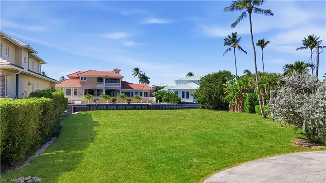 a view of a house with a big yard and potted plants