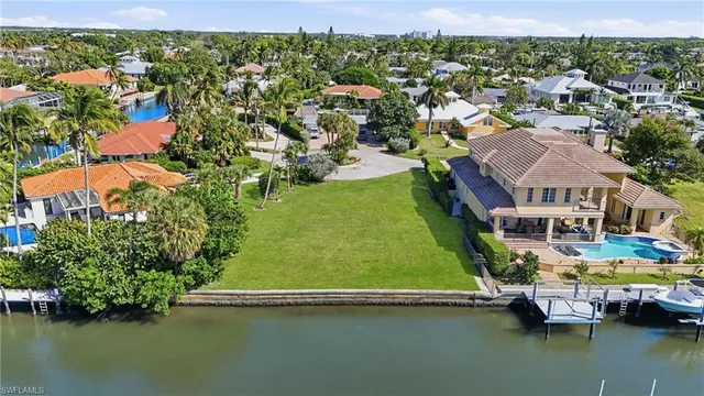 an aerial view of residential houses with outdoor space and swimming pool