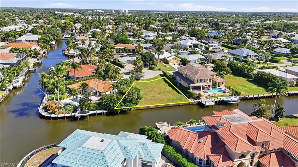 1510 Mullet Lane Naples, FL 34102 - Photo 7 of 8 an aerial view of a house with a lake view