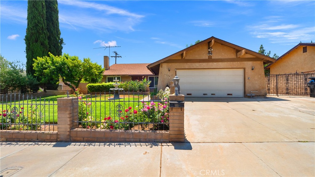 7198 Pico Avenue Riverside, CA 92509 - Photo 1 of 1 a front view of a house with a yard and garage