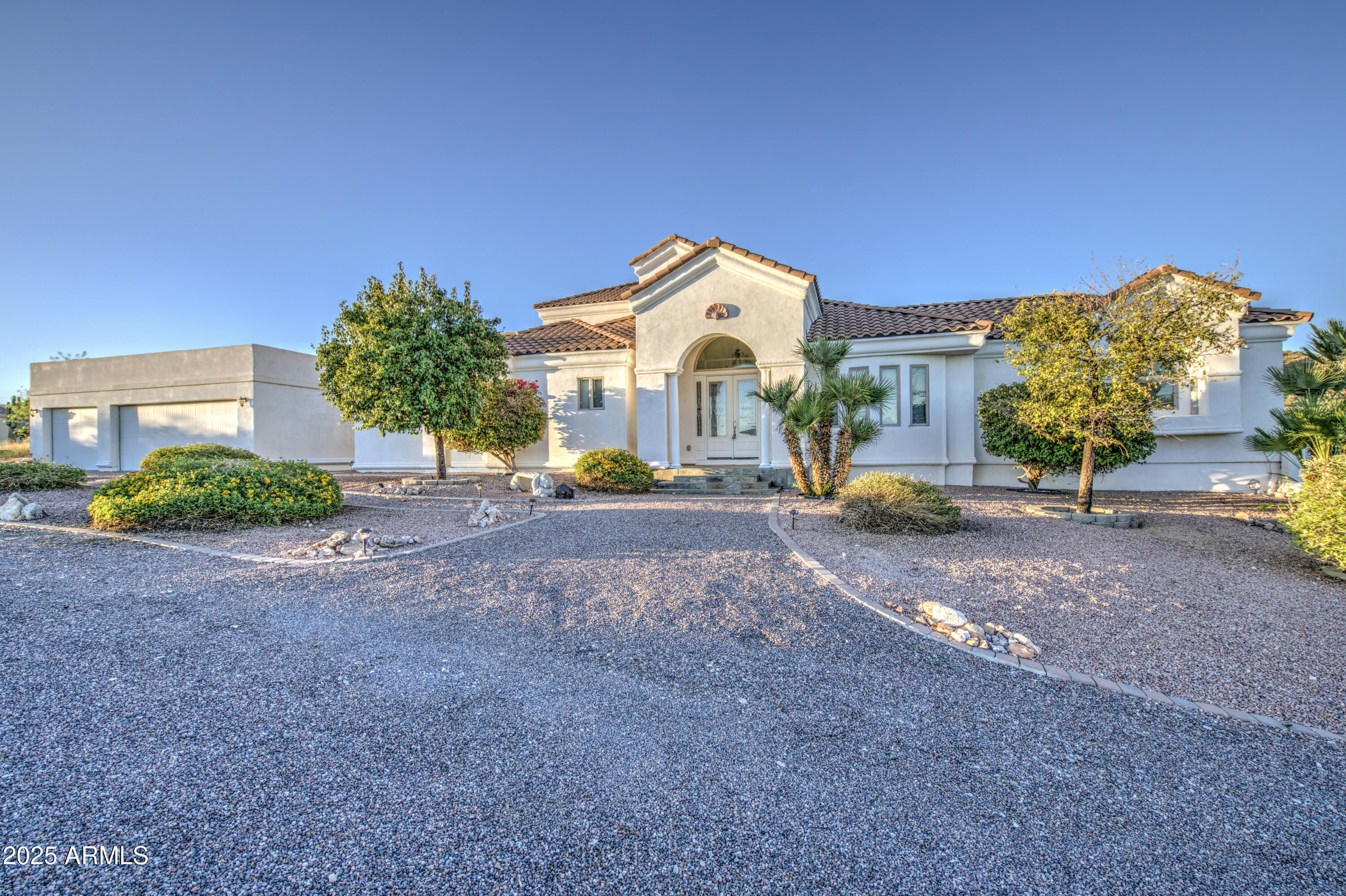 5238 North Explorer Road Apache Junction, AZ 85119 - Photo 11 of 109 a front view of a house with a yard and a garage
