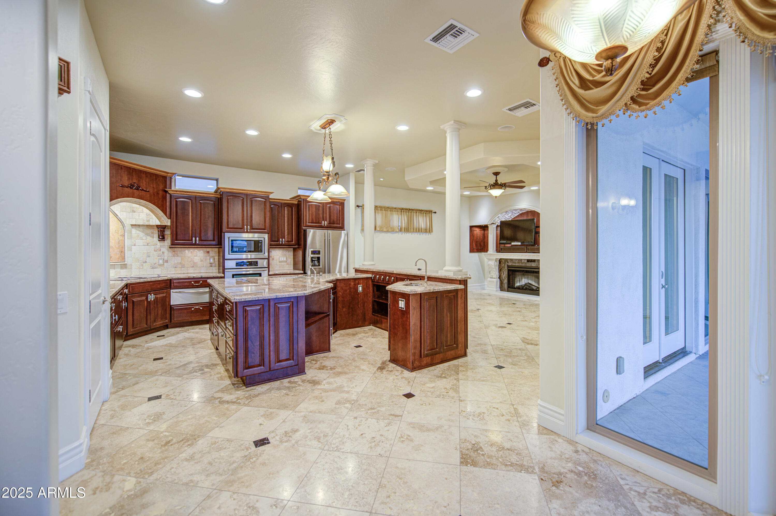 5238 North Explorer Road Apache Junction, AZ 85119 - Photo 21 of 109 a kitchen with stainless steel appliances kitchen island granite countertop a refrigerator and a sink