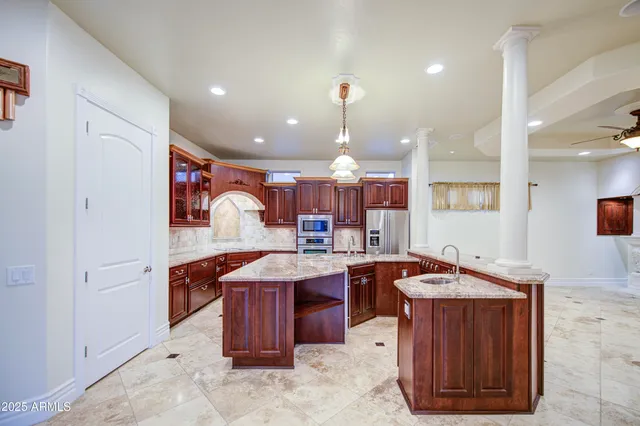 a kitchen with stainless steel appliances granite countertop a stove and a sink