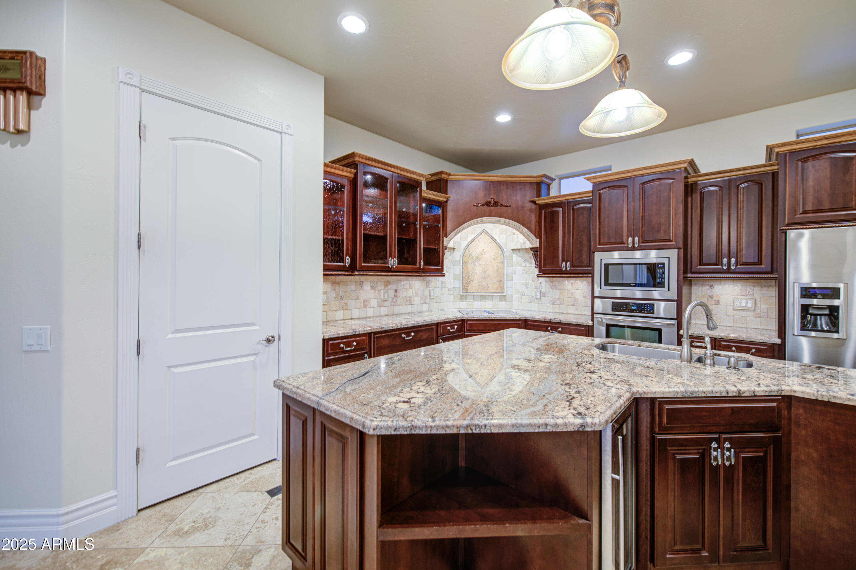 5238 North Explorer Road Apache Junction, AZ 85119 - Photo 25 of 109 a view of kitchen island a sink and a refrigerator