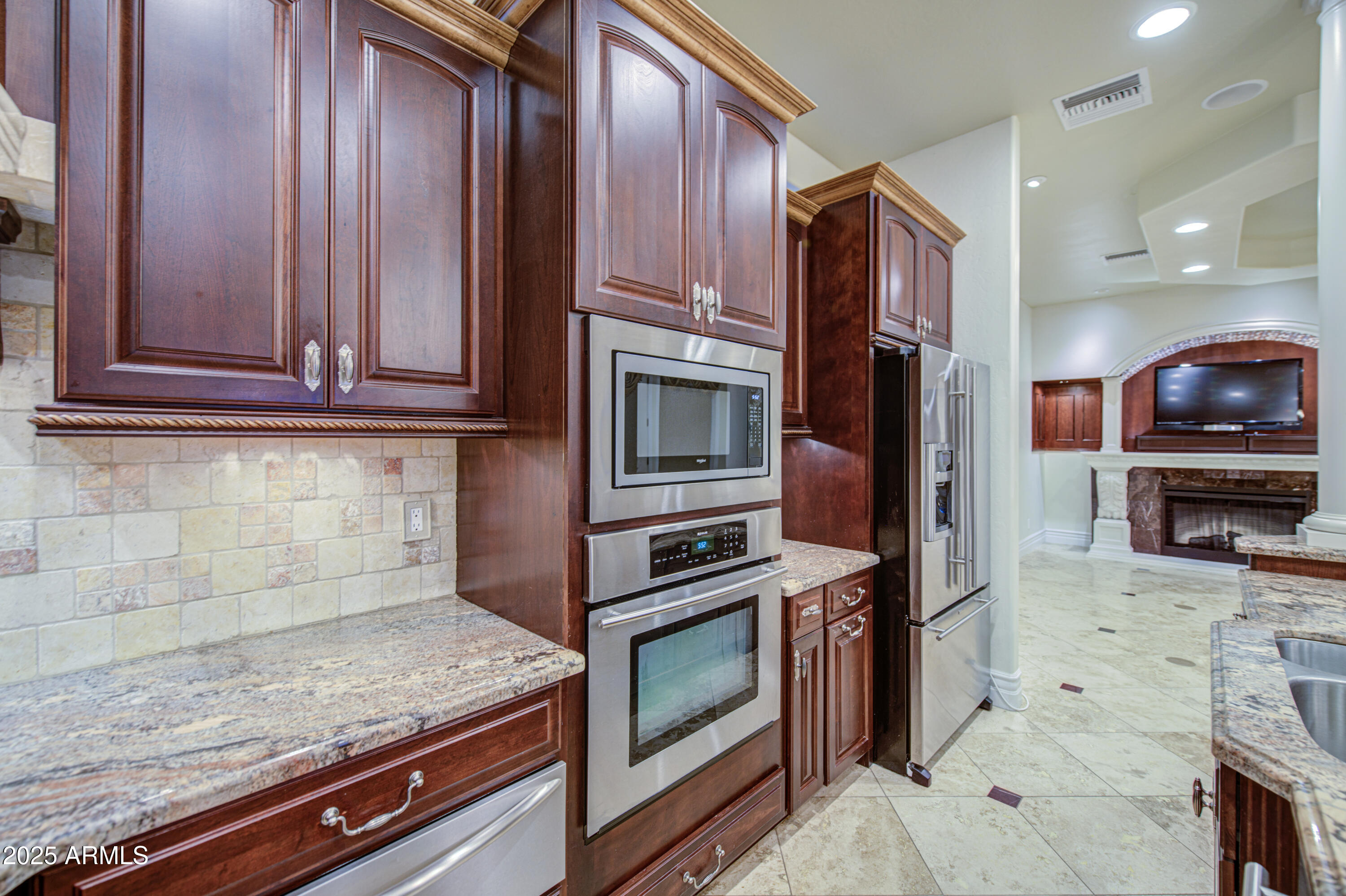 5238 North Explorer Road Apache Junction, AZ 85119 - Photo 28 of 109 a kitchen with stainless steel appliances granite countertop a stove microwave and refrigerator