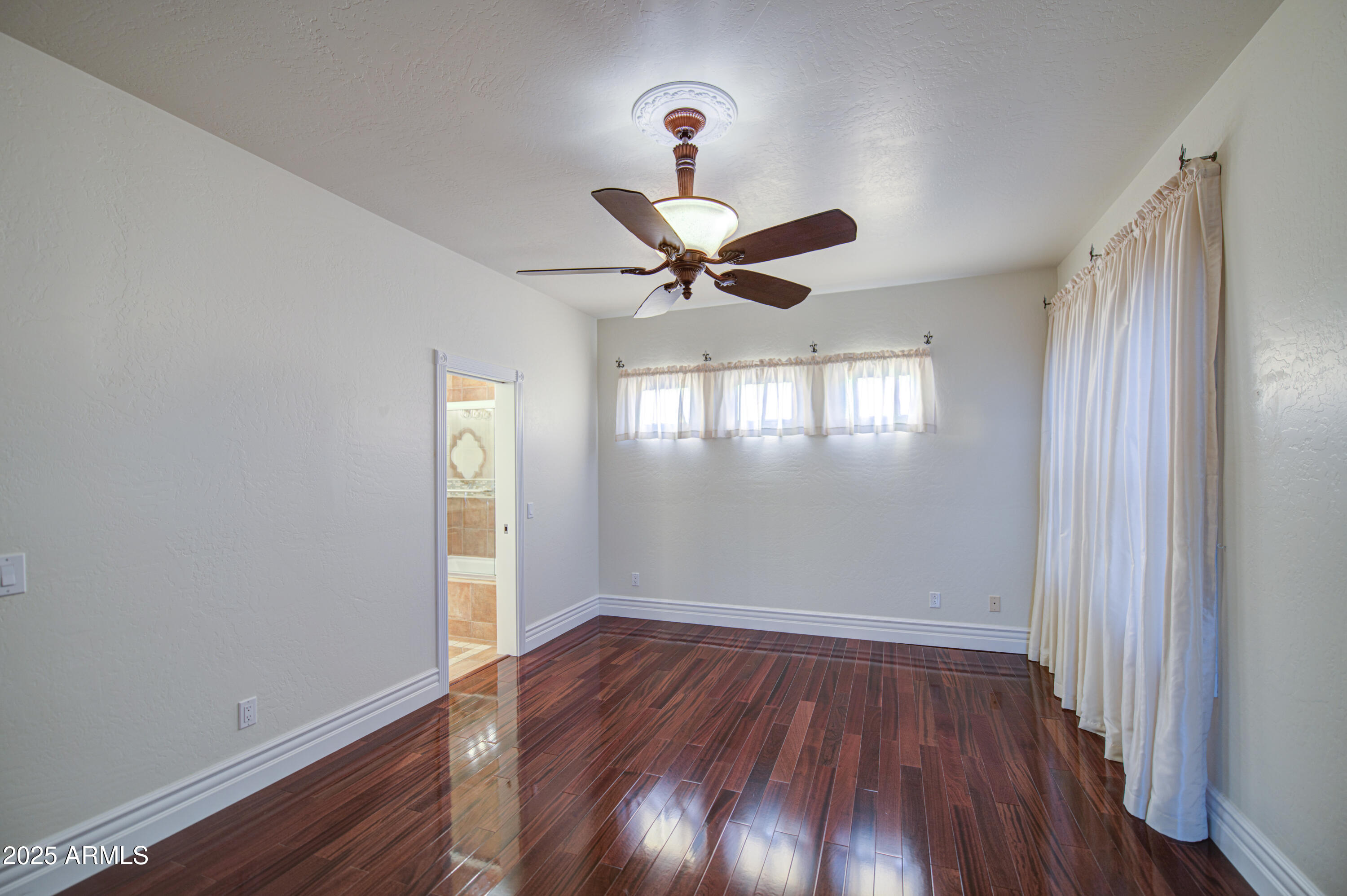 5238 North Explorer Road Apache Junction, AZ 85119 - Photo 50 of 109 a view of an empty room with wooden floor and a window