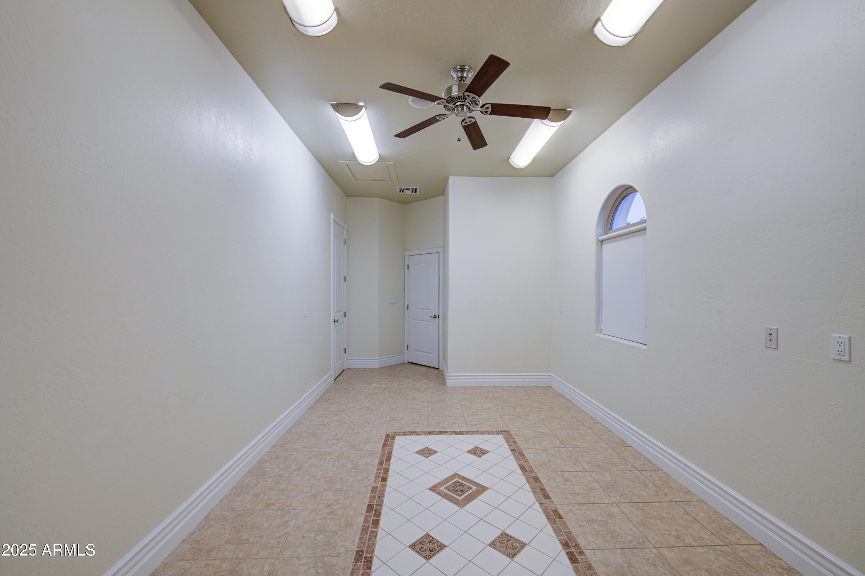 5238 North Explorer Road Apache Junction, AZ 85119 - Photo 55 of 109 an empty room with a ceiling fan and a window