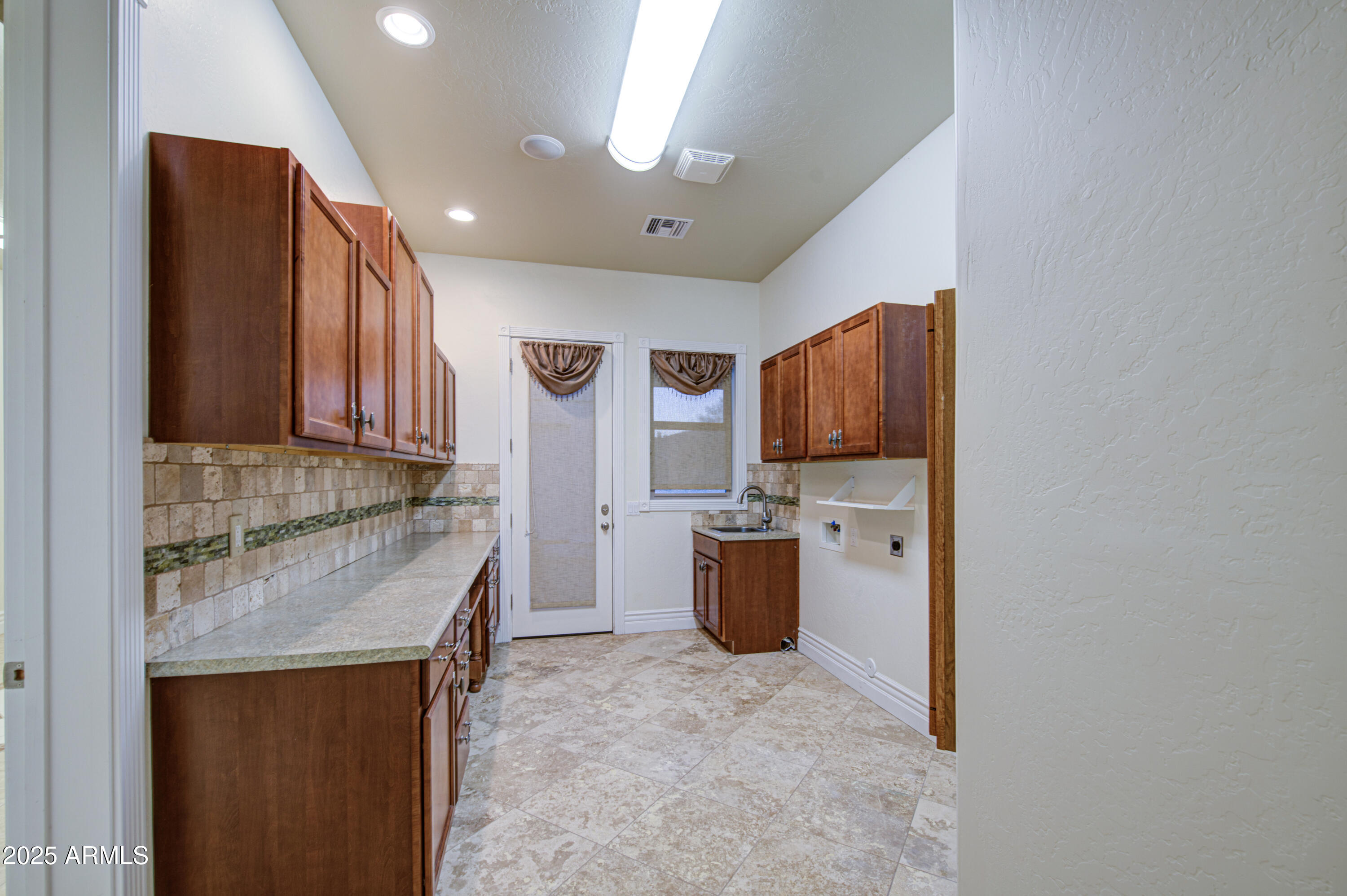 5238 North Explorer Road Apache Junction, AZ 85119 - Photo 63 of 109 a kitchen with stainless steel appliances granite countertop a sink refrigerator and microwave