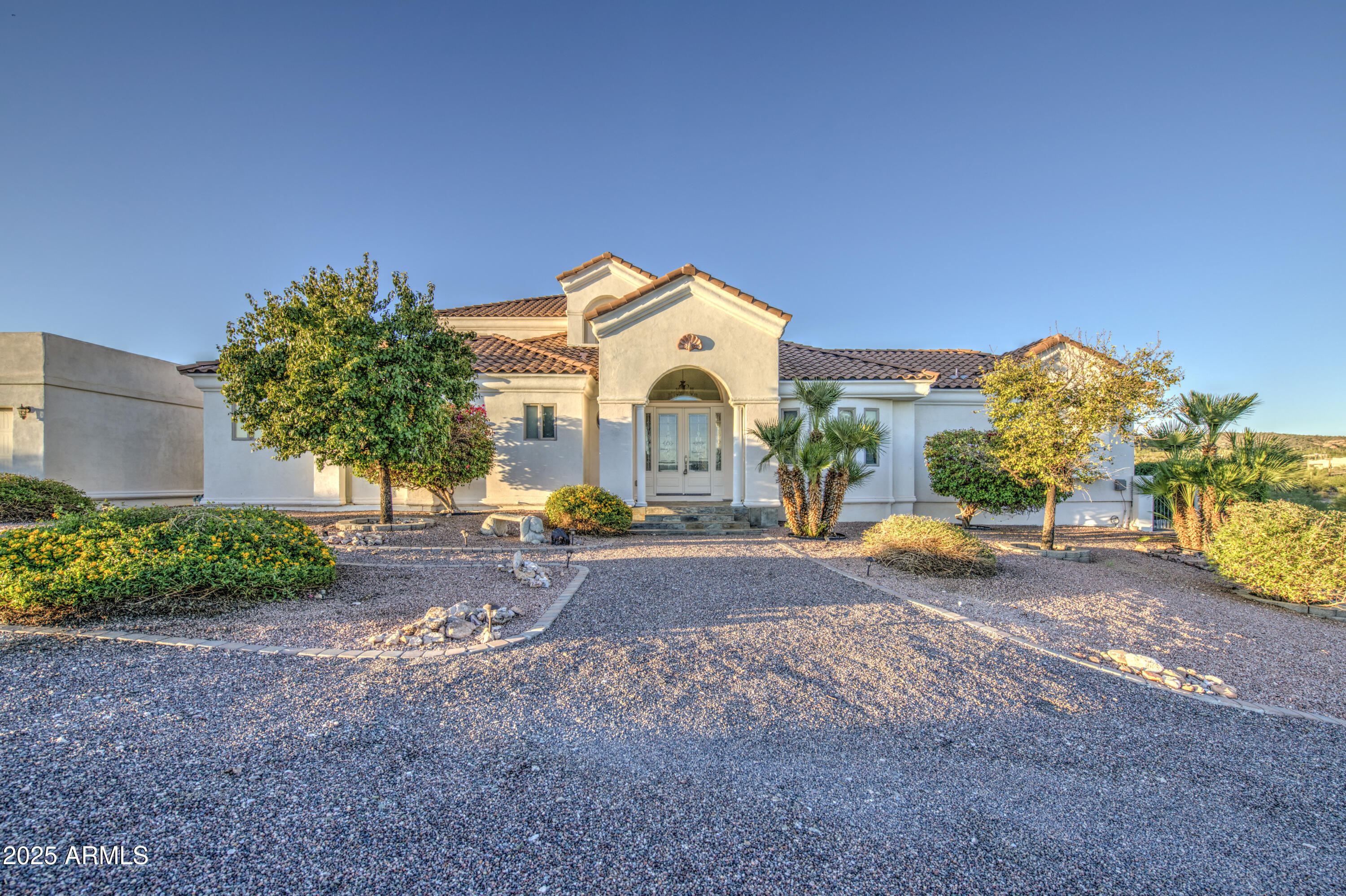 5238 North Explorer Road Apache Junction, AZ 85119 - Photo 8 of 109 a front view of a house with a yard and garage