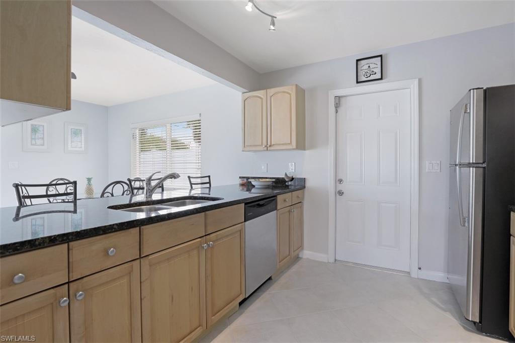 701 93rd Avenue North Naples, FL 34108 - Photo 13 of 33 a kitchen with a sink and cabinets
